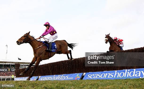 Big Zeb ridden by Barry Geraghty jumps the final fence ahead of Forpadydeplasterer ridden by Tony McCoy during the Seasons Holidays Queen Mother...