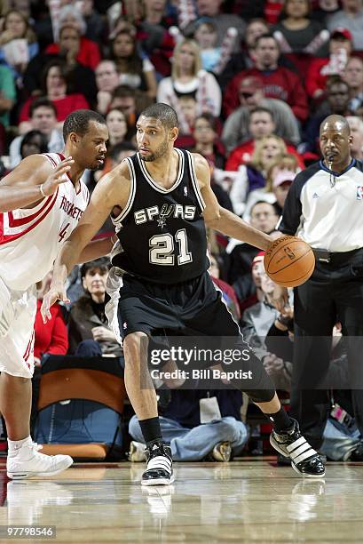 Tim Duncan of the San Antonio Spurs moves the ball against Chuck Hayes of the Houston Rockets during the game at Toyota Center on February 26, 2010...