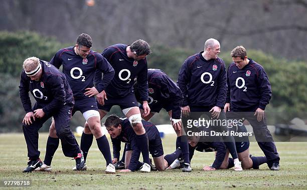Toby Flood and Matt Banahan crawl through the legs of team mates in the warm up during the England training session held at Pennyhill Park on March...