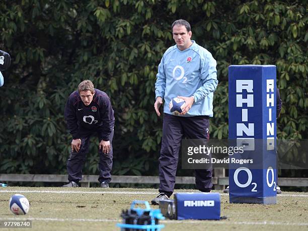 Jonny Wilkinson looks dejected as head coach Martin Johnson looks on during the England training session held at Pennyhill Park on March 17, 2010 in...