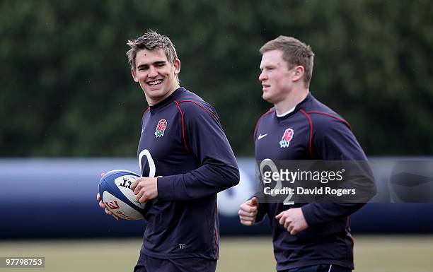 Toby Flood smiles with team mate Chris Asthon during the England training session held at Pennyhill Park on March 17, 2010 in Bagshot, England.