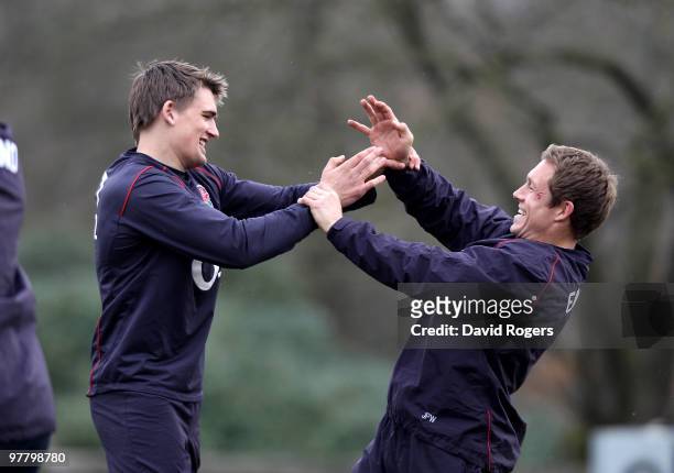 Jonny Wilkinson playfully fights with team mate Tobby Flood in a warm up session during the England training session held at Pennyhill Park on March...