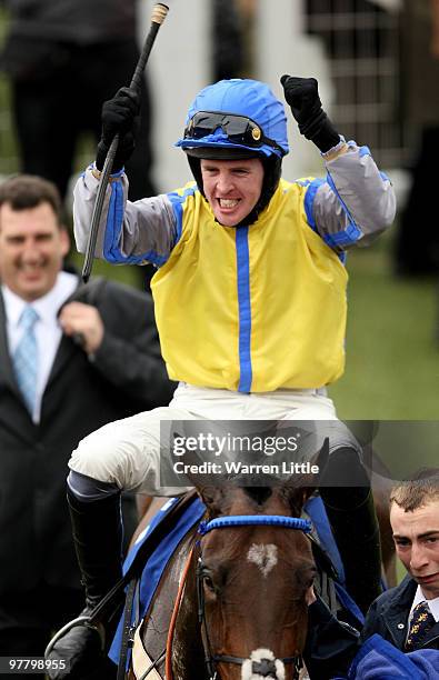 Jason Maguire celebrates on Peddlers Cross after winning The Neptune Investment Management Novices' Hurdle Race during Day Two of the Cheltenham...