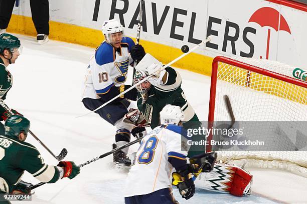 Andy McDonald of the St. Louis Blues has his shot deflected into the air by goaltender Josh Harding of the Minnesota Wild during the game at the Xcel...