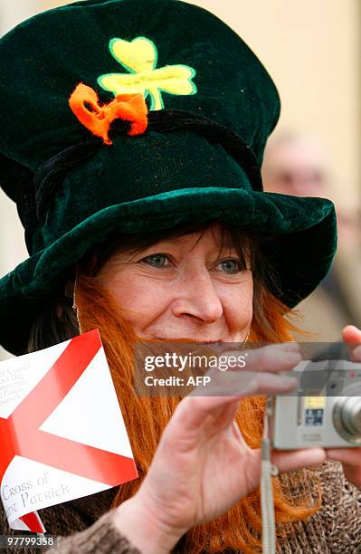 Woman watches the St.Patrick Day parade in Downpatrick, Northern Ireland on March 17, 2010. The traditional feast day of Ireland patron's saint has...