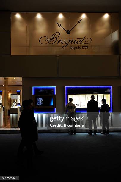 Visitors look at watches at the Breguet stand at the Baselworld watch fair in Basel, Switzerland, on Wednesday, March 17, 2010. The Baselworld Watch...