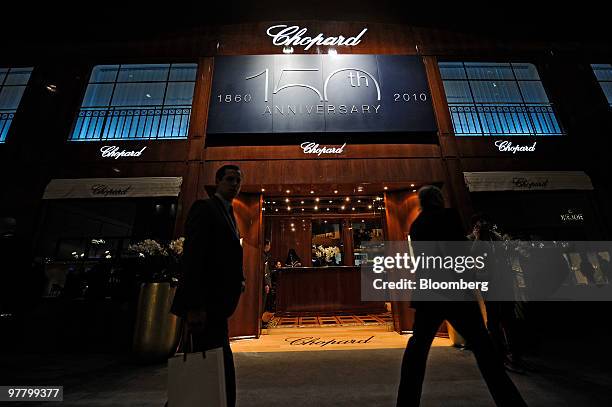 Visitors walk by the Chopard stand at the Baselworld watch fair in Basel, Switzerland, on Wednesday, March 17, 2010. The Baselworld Watch Fair opens...
