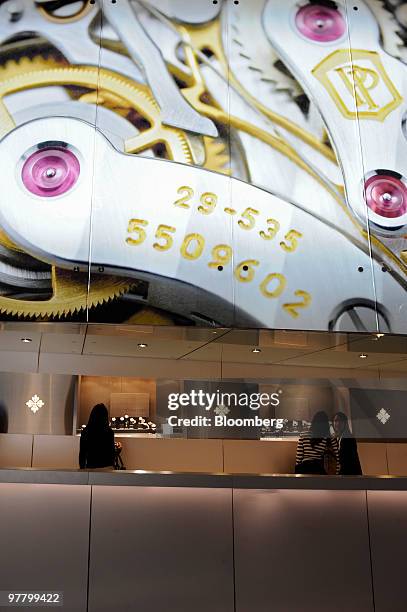 Visitors looks at watches at the Patek Philippe stand at the Baselworld watch fair in Basel, Switzerland, on Wednesday, March 17, 2010. The...