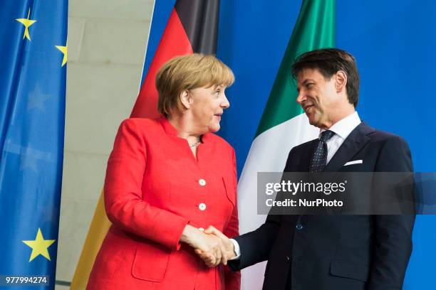 German Chancellor Angela Merkel and Italian Prime Minister Giuseppe Conte shake hands after giving a statement to the press before their meeting at...