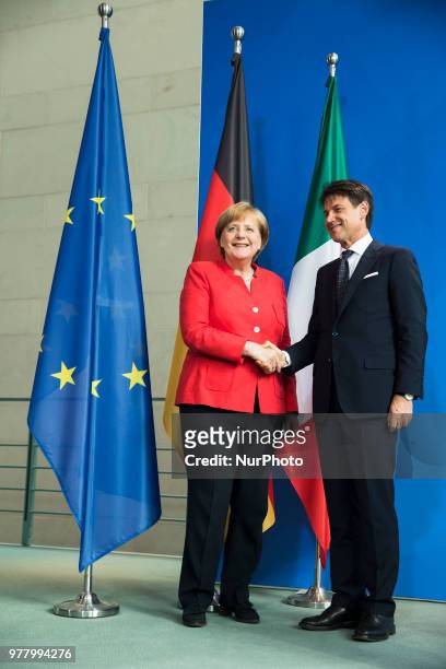 German Chancellor Angela Merkel and Italian Prime Minister Giuseppe Conte shake hands after giving a statement to the press before their meeting at...
