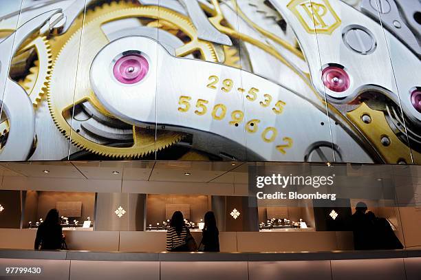 Visitors looks at watches at the Patek Philippe stand at the Baselworld watch fair in Basel, Switzerland, on Wednesday, March 17, 2010. The...