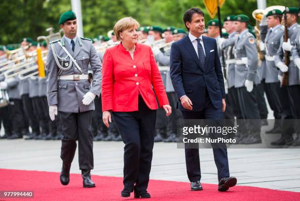 German Chancellor Angela Merkel and Italian Prime Minister Giuseppe Conte review the guard of honour at the Chancellery in Berlin, Germany on June...