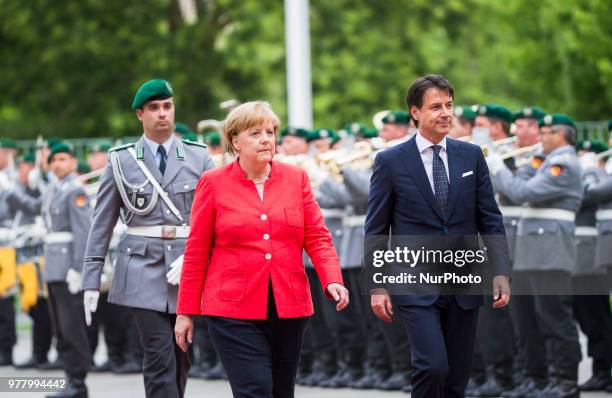 German Chancellor Angela Merkel and Italian Prime Minister Giuseppe Conte review the guard of honour at the Chancellery in Berlin, Germany on June...