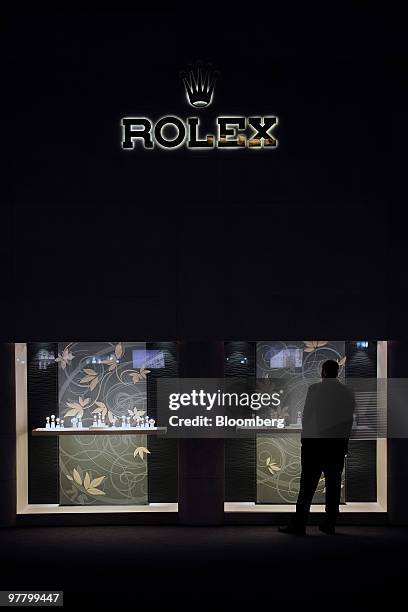 Visitor looks at watches at the Rolex stand at the Baselworld watch fair in Basel, Switzerland, on Wednesday, March 17, 2010. The Baselworld Watch...