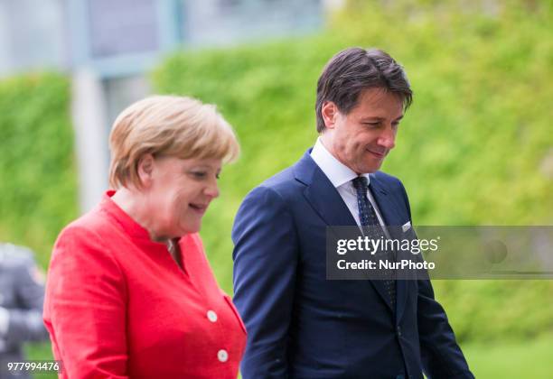 German Chancellor Angela Merkel and Italian Prime Minister Giuseppe Conte review the guard of honour at the Chancellery in Berlin, Germany on June...