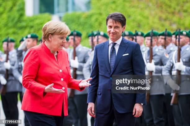 German Chancellor Angela Merkel and Italian Prime Minister Giuseppe Conte review the guard of honour at the Chancellery in Berlin, Germany on June...