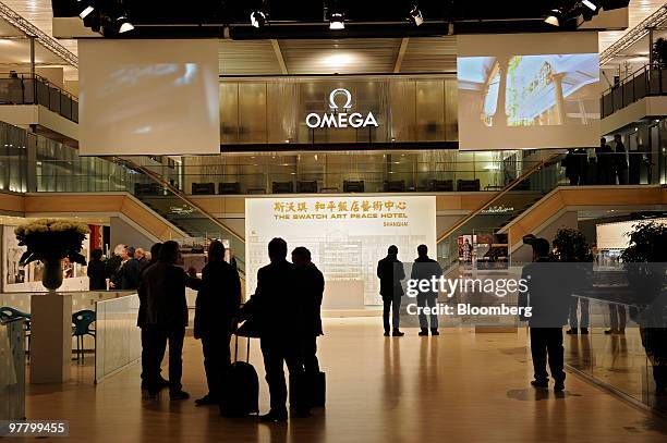 Visitors are seen at the Omega stand at the Baselworld watch fair in Basel, Switzerland, on Wednesday, March 17, 2010. The Baselworld Watch Fair...