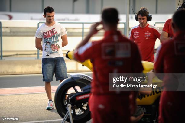 Hector Barbera of Spain and Team Aspar looks at his bike in the pits during the first day of testing at Losail Circuit on March 17, 2010 in Doha,...