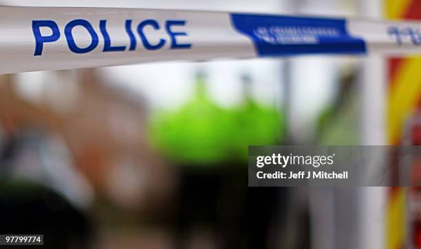 Police banner is displayed outside a house in St Andrews Avenue following a shooting incident on March 17, 2010 in Bishopbriggs, near Glasgow,...