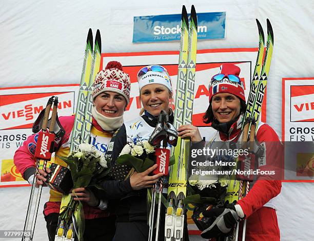 Justyna Kowalczyk of Poland, Anna Olsson of Sweden and Marit Bjoergen of Norway celebrate after the individual sprint Cross Country Skiing during the...