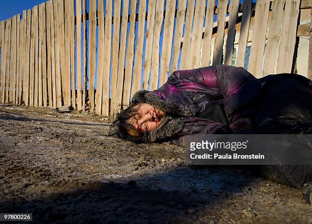 Drunk woman, who fell and hit her head is left without any help, passed out along the street on March 16, 2010 in Ulaan Baatar, Mongolia. Mongolia...