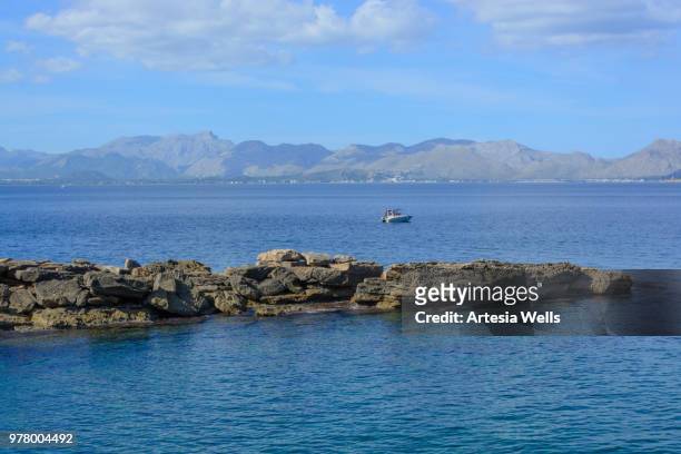 boat on pollensa bay - pollensa stock pictures, royalty-free photos & images