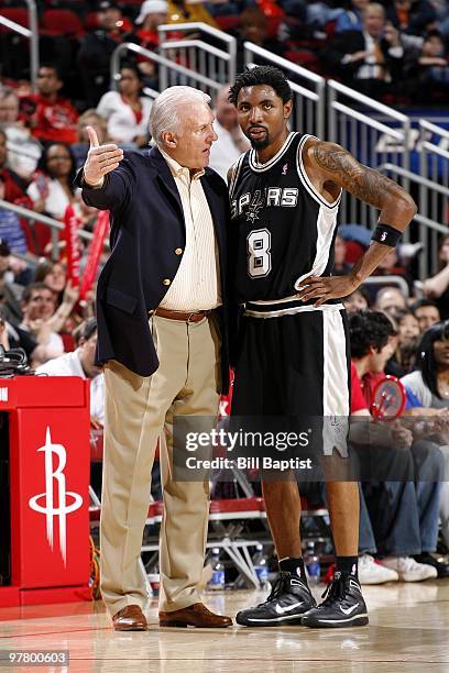 Head coach Gregg Popovich talks with Roger Mason Jr. #8 of the San Antonio Spurs during the game against the Houston Rockets at Toyota Center on...