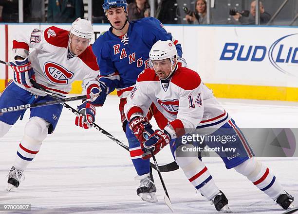 Tomas Plekanec and Andrei Kostitsyn of the Montreal Canadiens skate against Brandon Dubinsky of the New York Rangers on March 16, 2010 at Madison...