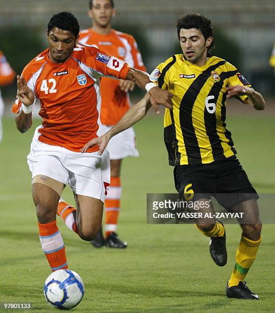 Kuwait's Kazima club player Yousef Nasser competes with Lebanon�s al-Ahed FC player Hussein al-Awieh during their 2011 AFC Cup football match in...