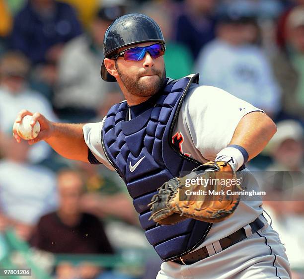 Alex Avila of the Detroit Tigers throws to first base against the Pittsburgh Pirates during the spring training game at McKechnie Field on March 17,...