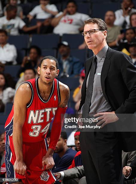 Devin Harris and head coach Kiki Vandeweghe of the New Jersey Nets stand on the court during the game against the Memphis Grizzlies on March 8, 2010...