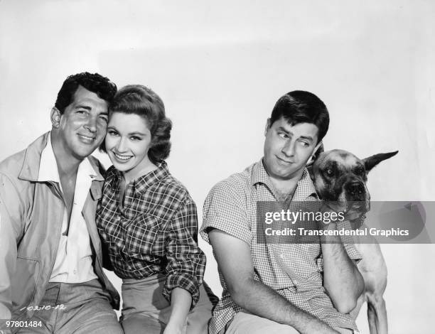Promotional portrait of American comedic team Dean Martin and Jerry Lewis as they pose with co-stars Pat Crowley and Mr. Bascomb for 'Hollywood or...