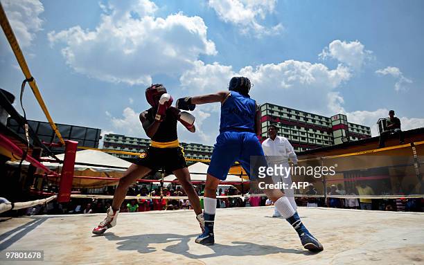 Two young women fight in a box ring set up in the street, on March 13, 2010 during an Olympic Street Box event, in the "23 de Enero" neighbourhood in...