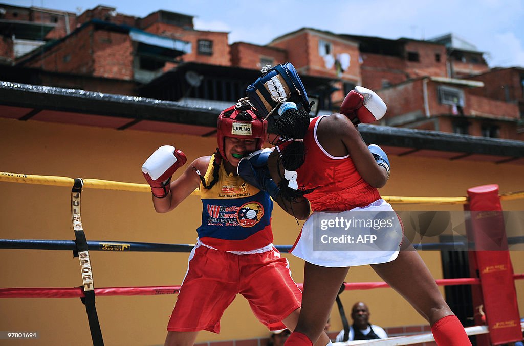 Two girls fight in a box ring set up in