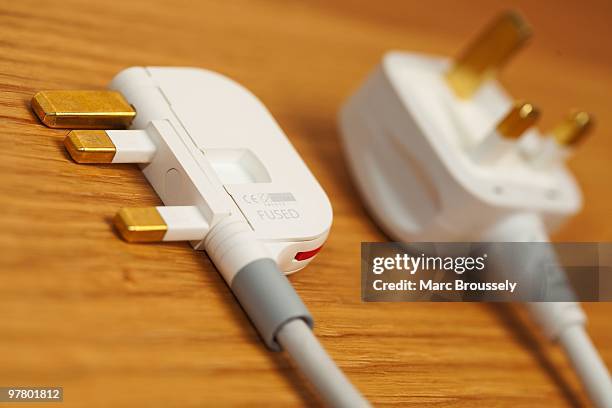 In this photo illustration a detail of the UK folding plug designed by Royal College of Art student Min-Kyu Choi is displayed in comparison to a...