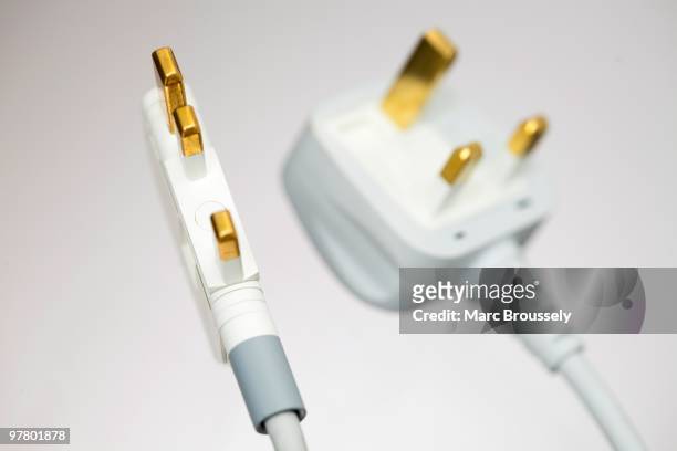 In this photo illustration a detail of the UK folding plug designed by Royal College of Art student Min-Kyu Choi is displayed in comparison to a...