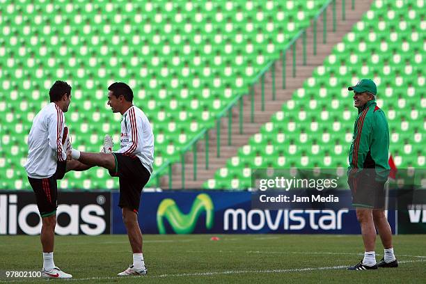 Mexico's players Jose Antonio Castro and Oscar Rojas exercise observed by the head coach Javier Aguirre during a training session at Territorio...