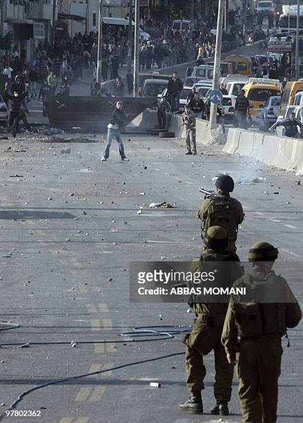 Palestinian youths hurl stones at Israeli soldiers during clashes on March 17, 2010 in the West Bank refugee camp of Qalandia. Tensions over...