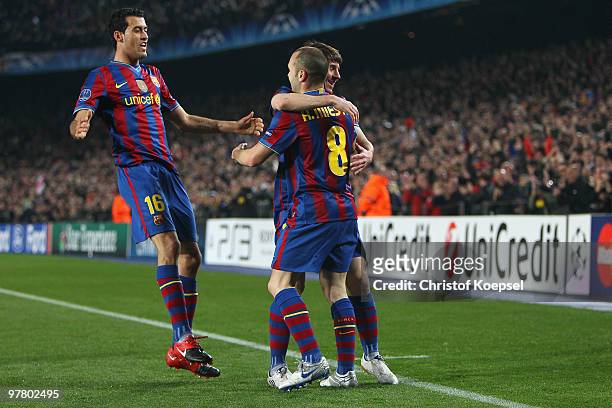 Lionel Messi of Barcelona celebrates the first goal with Sergio Busquets of Barcelona and Andrés Iniesta during the UEFA Champions League round of...