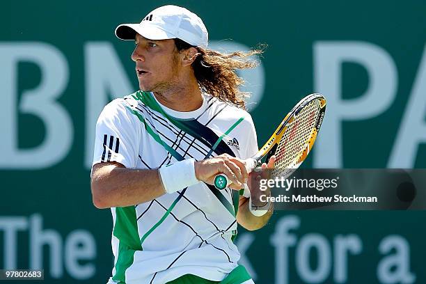 Juan Monaco of Argentina returns a shot to Guillermo Garcia-Lopez during the BNP Paribas Open on March 17, 2010 at the Indian Wells Tennis Garden in...