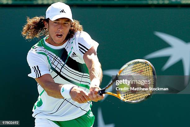 Juan Monaco of Argentina returns a shot to Guillermo Garcia-Lopez during the BNP Paribas Open on March 17, 2010 at the Indian Wells Tennis Garden in...