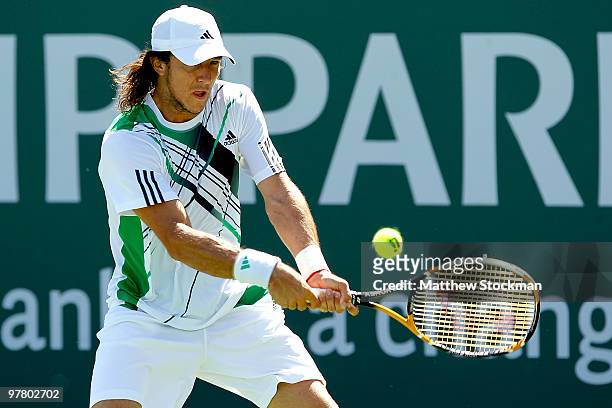 Juan Monaco of Argentina returns a shot to Guillermo Garcia-Lopez during the BNP Paribas Open on March 17, 2010 at the Indian Wells Tennis Garden in...
