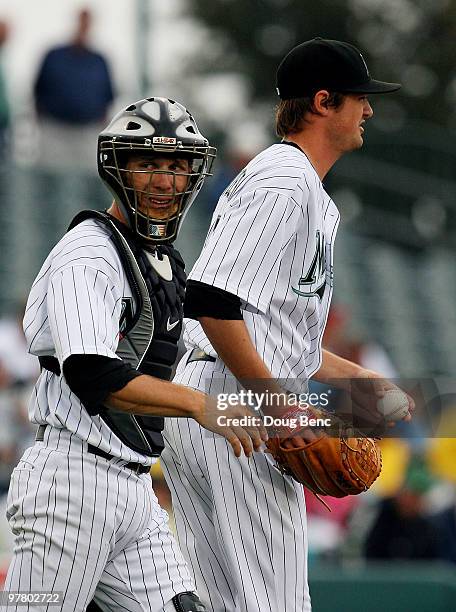 Catcher Brad Davis goes to the mound to talk with starting pitcher Andrew Miller of the Florida Marlins while taking on the Atlanta Braves at Roger...