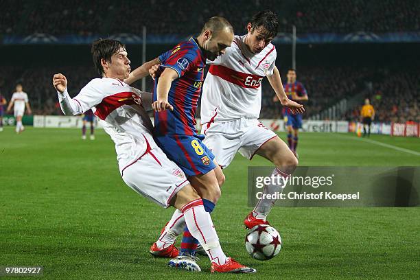 Stefano Celozzi of Stuttgart and Christian Traesch of Stuttgart challenges Andrés Iniesta of Barcelona during the UEFA Champions League round of...