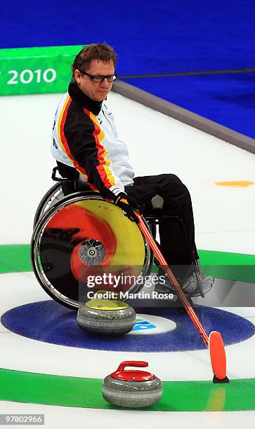 Jens Jaeger of Germany helps his teammate line up a stone during the Wheelchair Curling Round Robin game between Canada and Germany on day six of the...