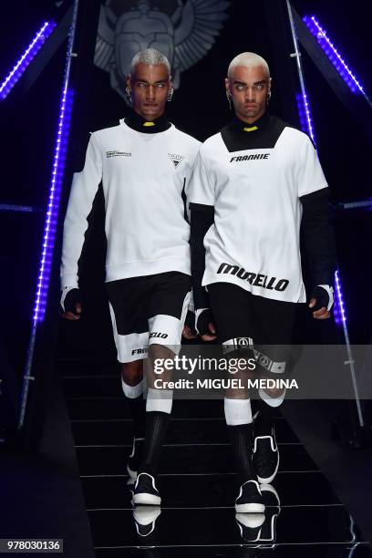Models present creations by Frankie Morello fashion house during the men and women's spring/summer 2019 collection fashion show in Milan, on June 18,...