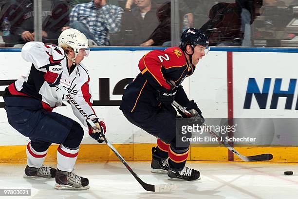 Keith Ballard of the Florida Panthers skates with the puck against Nicklas Backstrom of the Washington Capitals at the BankAtlantic Center on March...