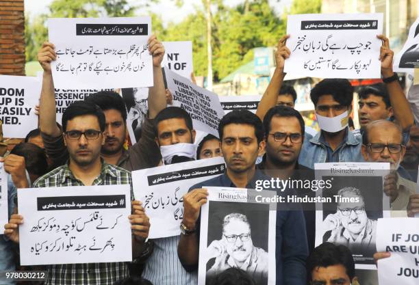 Journalists of Rising Kashmir joined by other journalists from various media hold placards during sit-in protest against the killing of Shujaat...