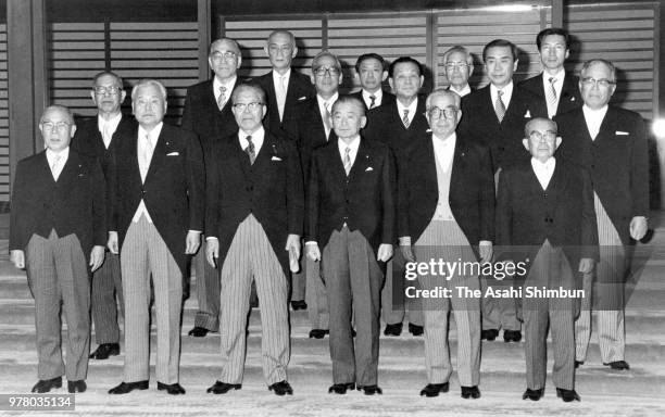 Prime Minister Noboru Takeshita and his new cabinet members pose for photographs after the attestation ceremony at the Imperial Palace on December...