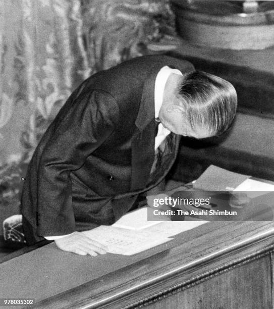 Prime Minister Noboru Takeshita bows after the consumption tax bills enacted at an Upper House plenary session at the Diet on December 24, 1988 in...